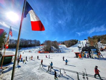 People on beach against sky during winter