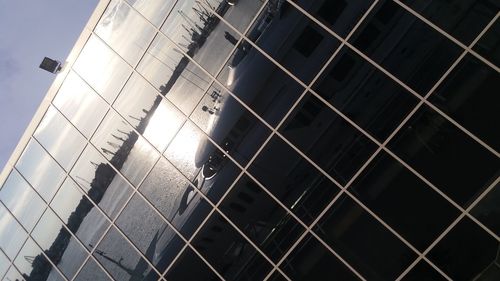 Low angle view of metal fence against sky