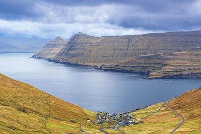 Scenic view of sea and mountains against sky