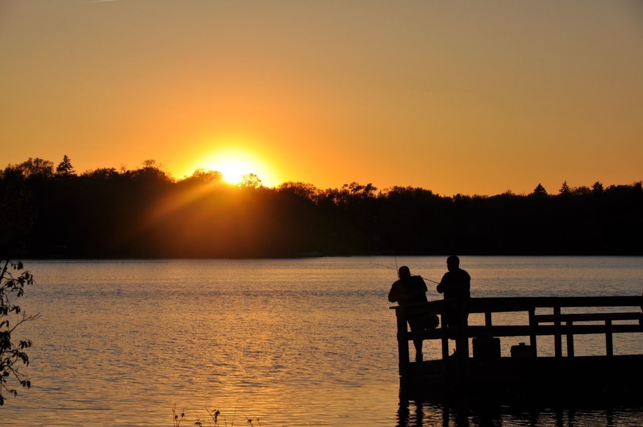 sunset, silhouette, sun, water, orange color, scenics, tranquil scene, beauty in nature, men, tranquility, nature, lake, sunlight, river, idyllic, leisure activity, lifestyles, sky, sitting