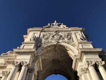 Low angle view of historic building against blue sky