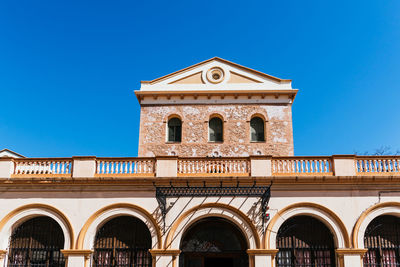 Low angle view of building against blue sky