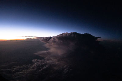 Scenic view of mountains against sky at night