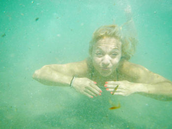 Portrait of woman swimming in sea