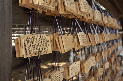 Close-up of clothes hanging on wood for sale