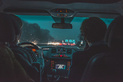 Rear view of people sitting in car