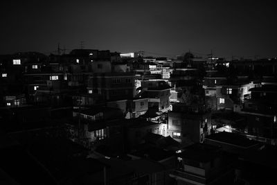 High angle view of buildings against clear sky at night