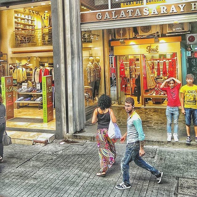 lifestyles, casual clothing, night, full length, leisure activity, store, person, men, rear view, shop, illuminated, retail, building exterior, standing, built structure, street, market