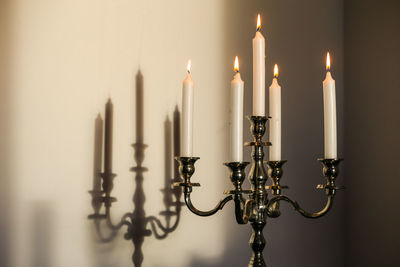 Candlestick holder by wall