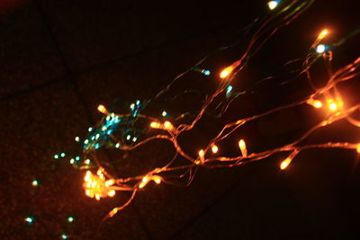 Low angle view of illuminated christmas lights at night