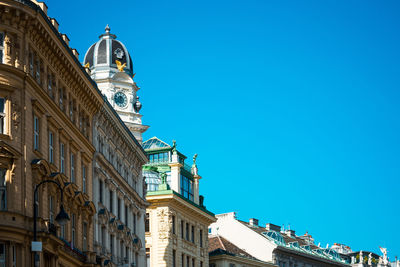 High section of built structures against clear blue sky