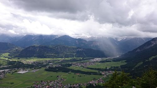 Scenic view of mountains against cloudy sky