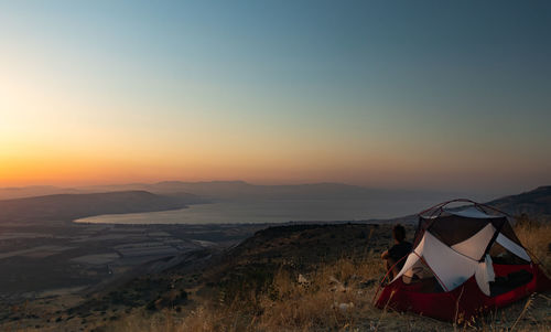 Scenic view of desert against clear sky during sunset