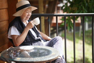 Side view of young woman using mobile phone