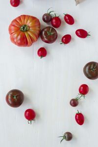 Close-up of red fruit over white background