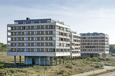 Aerial view of the dunes with three floating residential buildings in hook of holland