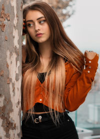 Portrait of beautiful young woman standing outdoors