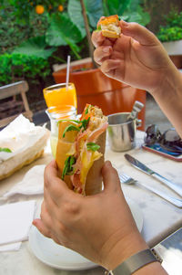 Cropped hand of woman holding food