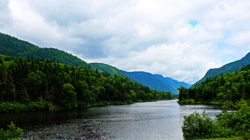 Scenic view of lake and mountains against sky