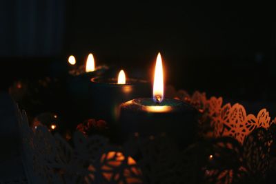 Close-up of lit candles in the dark