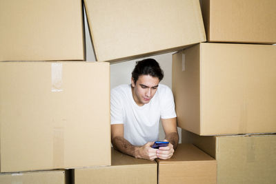 Young man holding camera in box