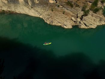 Distant view of people canoeing on sea