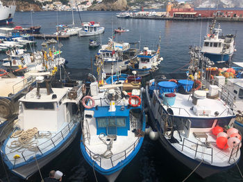 High angle view of boats moored at harbor in city