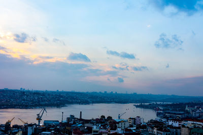 High angle view of townscape by sea against sky