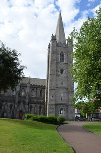 Low angle view of church against cloudy sky