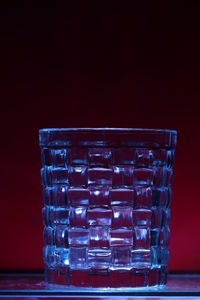 Close-up of glass stack on table against black background