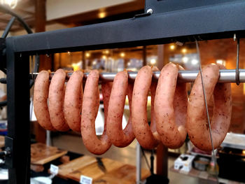 Side view of sausages on rack