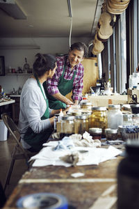 Rear view of woman preparing food at home