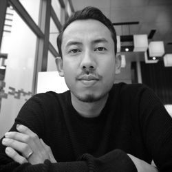 Portrait of young man sitting at home