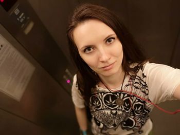 High angle portrait of woman standing in elevator