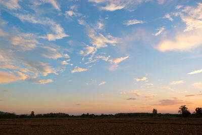 Scenic view of field against sky during sunset