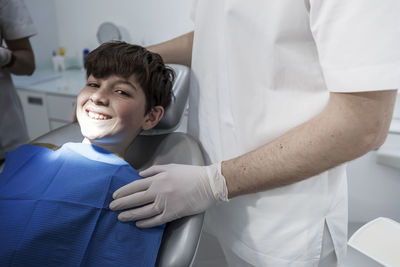 Midsection of doctor examining patient