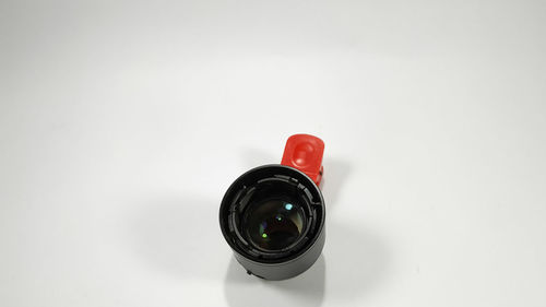 High angle view of camera on table against white background