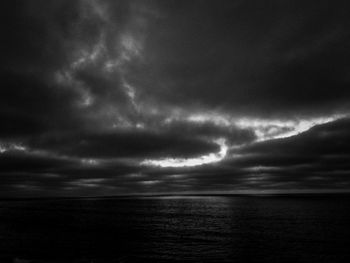 Scenic view of sea against storm clouds