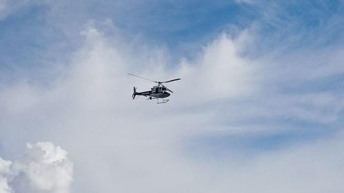 Low angle view of helicopter against the sky