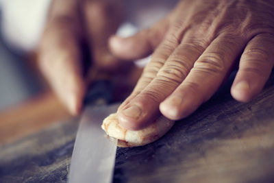 Close-up of hand cutting shrimp