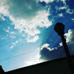 Low angle view of silhouette person against sky