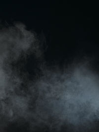 Abstract image of fog over black background