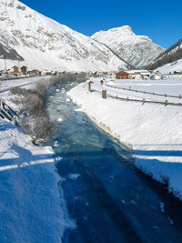 Snow covered mountains against clear blue sky