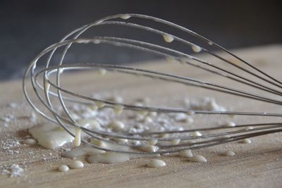 Close-up of wire whisk on table in kitchen