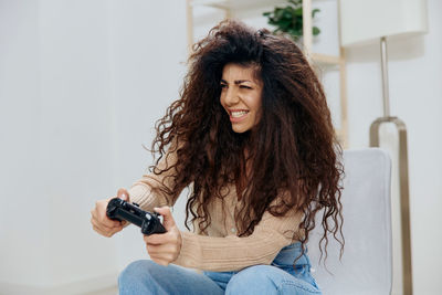 Woman playing video game at home