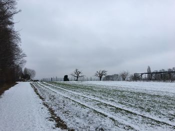 Snow covered landscape against sky