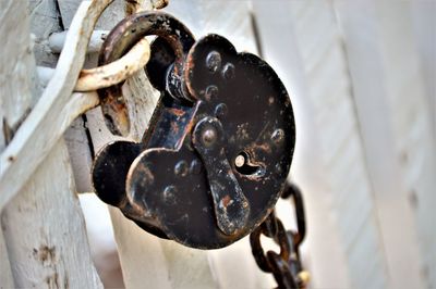 Close-up of old rusty padlock on gate