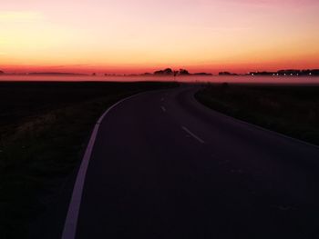 Country road against sky during sunset