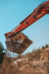 Low angle view of construction site against clear blue sky