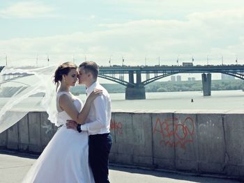 Friends standing on bridge